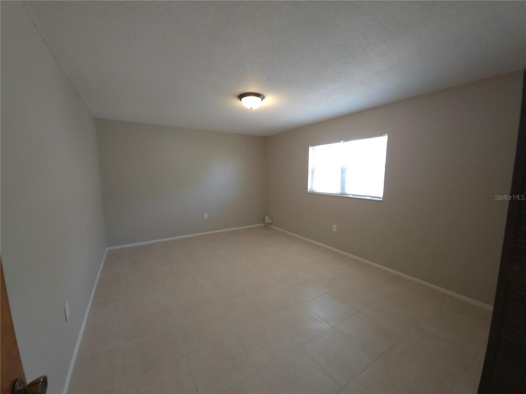 4204 East Okara Road Tampa, FL 33617 - Photo 12 of 21 an empty room with windows