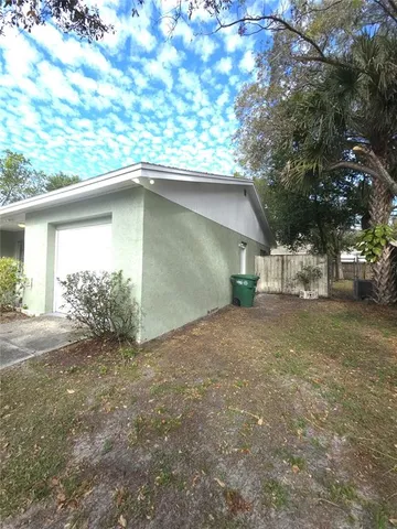 a view of a house with a yard and garage
