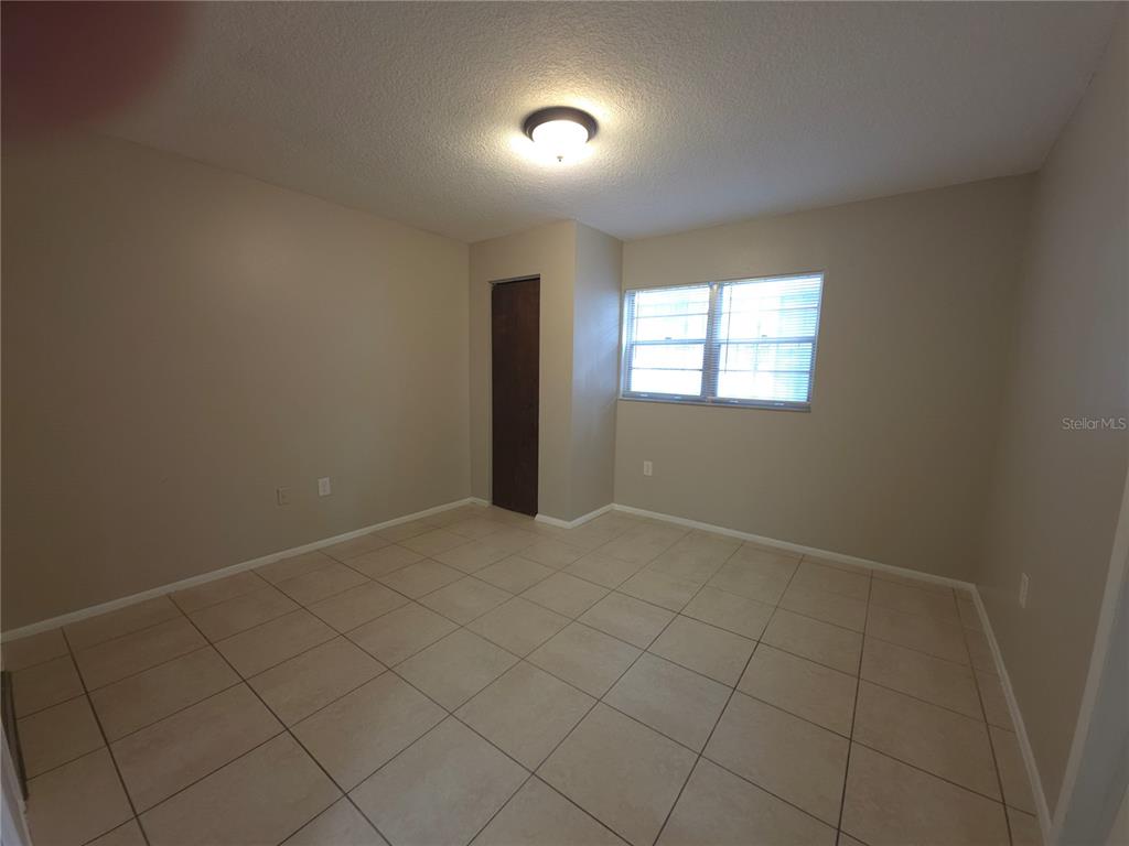 4204 East Okara Road Tampa, FL 33617 - Photo 10 of 21 an empty room with windows
