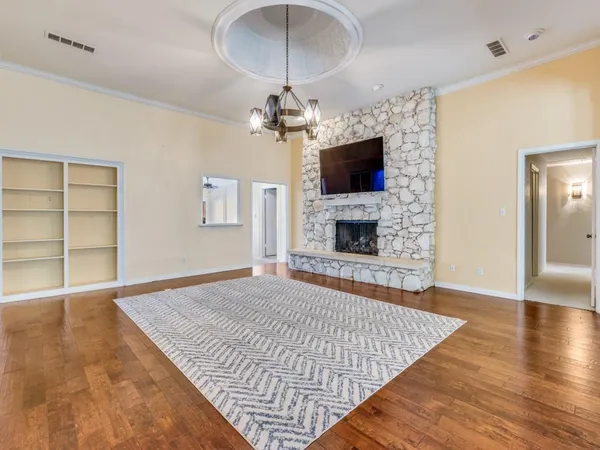 a living room with a fireplace cabinet and a flat screen tv