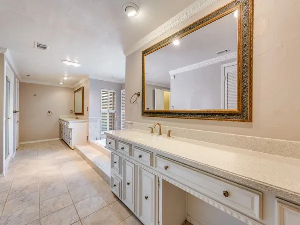 a bathroom with a sink a mirror and a vanity