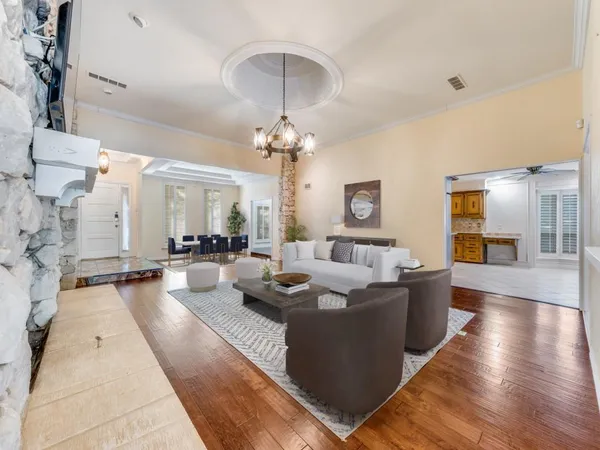 a living room with fireplace furniture and a chandelier