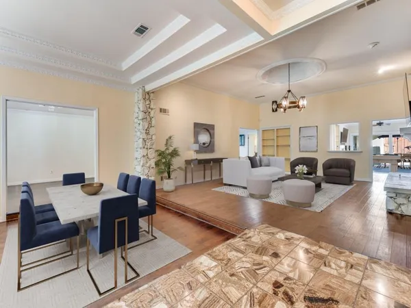 a living room with fireplace furniture and a chandelier