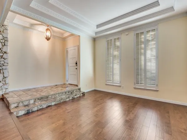a view of a livingroom with wooden floor and a window