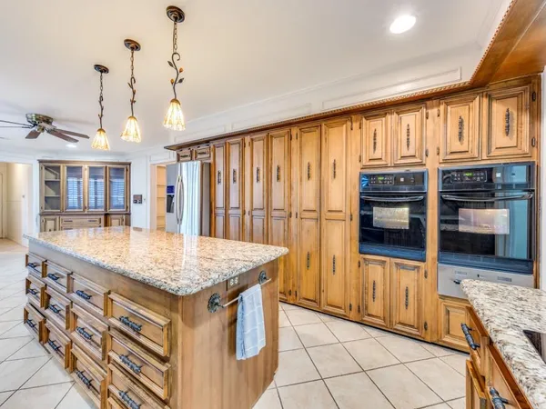 a kitchen with stainless steel appliances granite countertop a stove and refrigerator