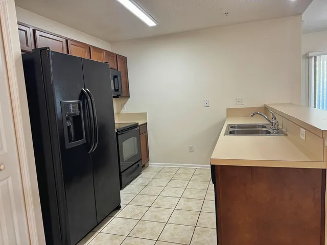a kitchen with a refrigerator and a sink