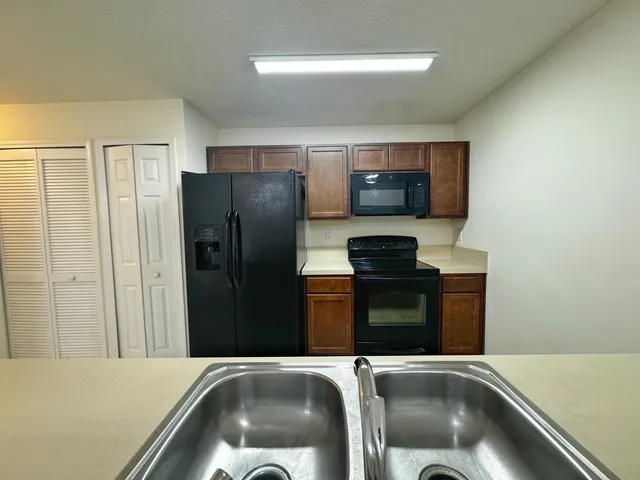 a kitchen with a refrigerator and a sink