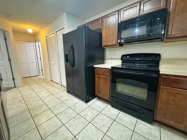 a kitchen with stainless steel appliances granite countertop a stove a microwave and a refrigerator
