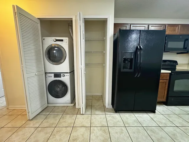 a view of a refrigerator and washer in a kitchen