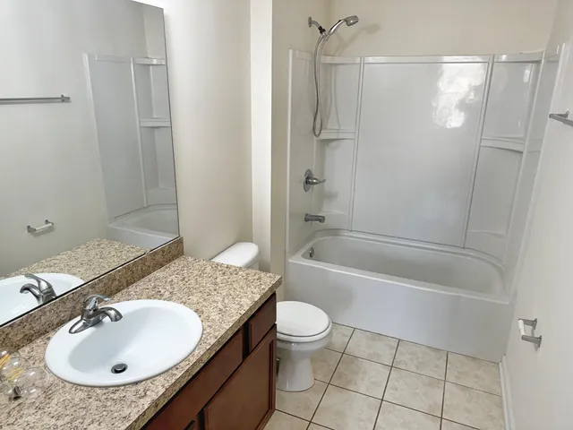 a bathroom with a sink toilet tub and shower