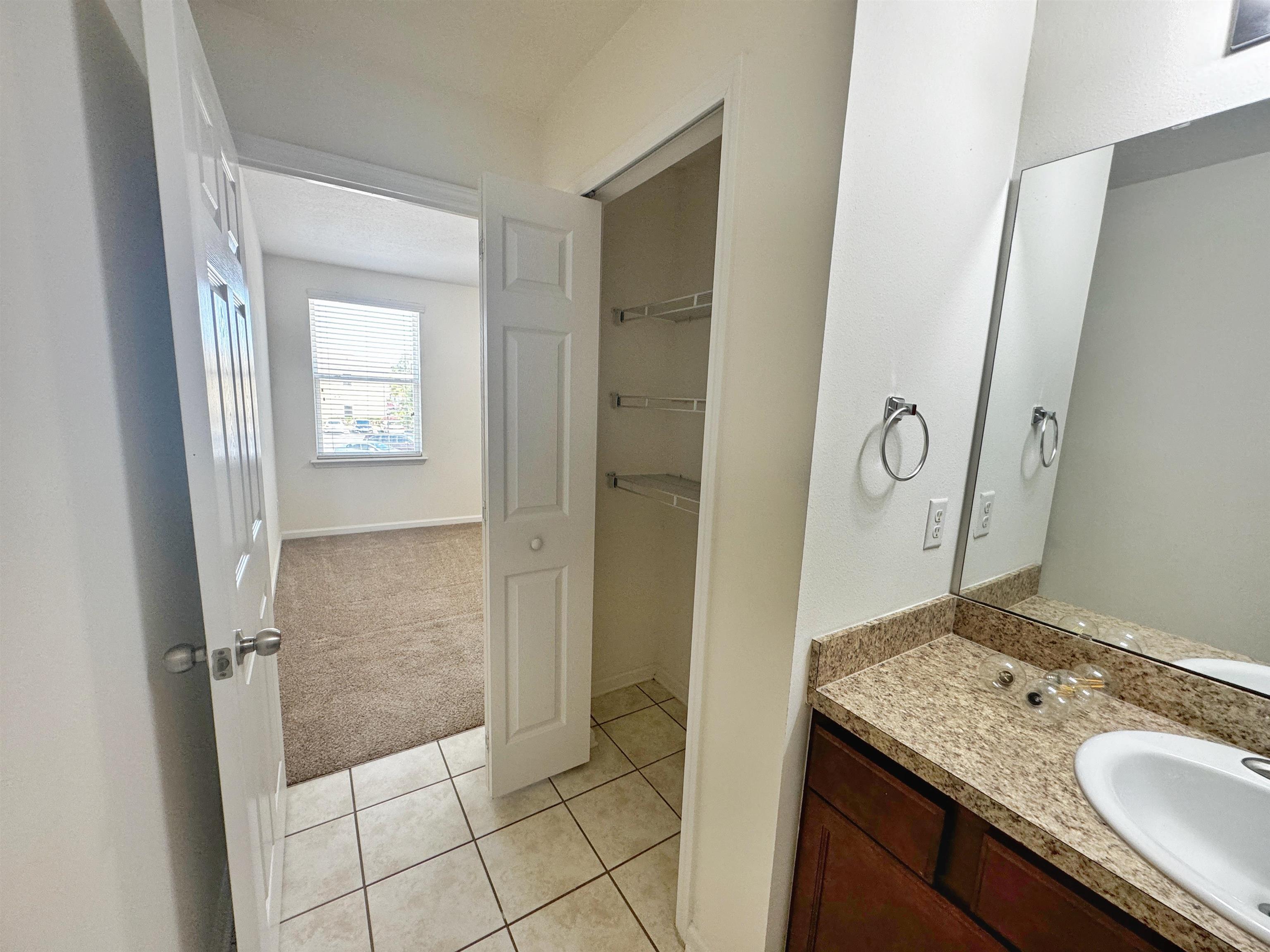 2261 Golden Lake Loop St. Augustine, FL 32084 - Photo 29 of 43 a bathroom with a granite countertop sink a mirror and a shower