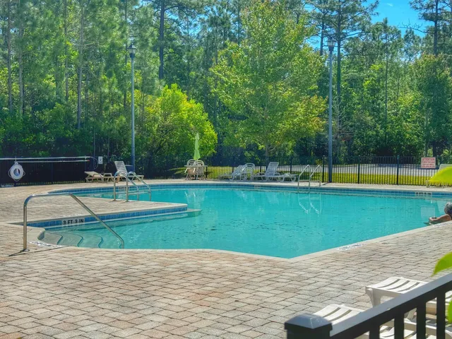 a view of a swimming pool with a yard