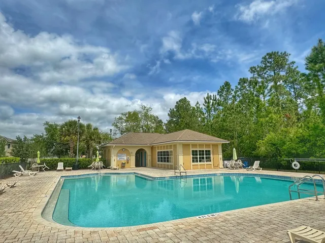 a view of a swimming pool with a yard