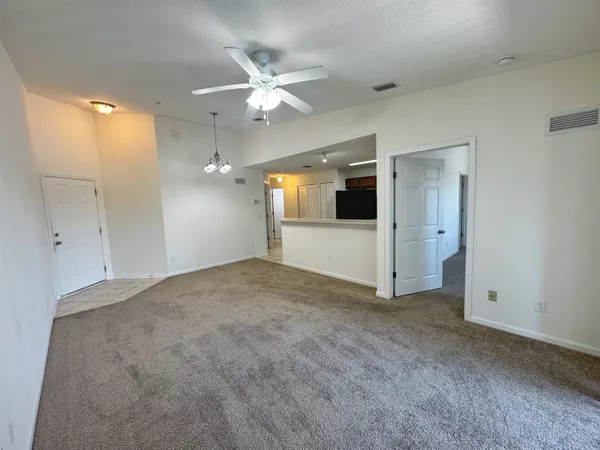an empty room with a bathroom and a mirror