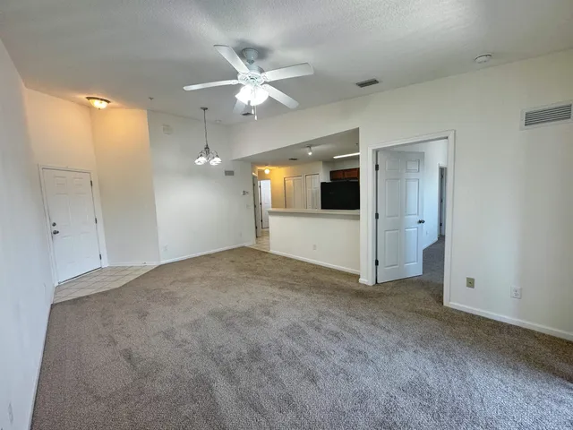 an empty room with a bathroom and a mirror