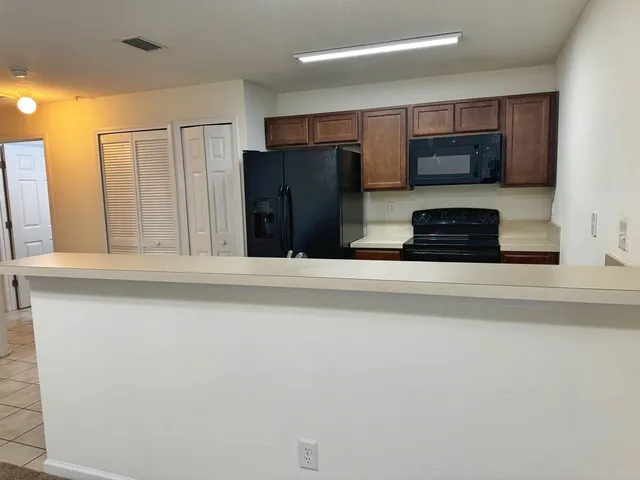 a kitchen with stainless steel appliances a refrigerator and a stove top oven