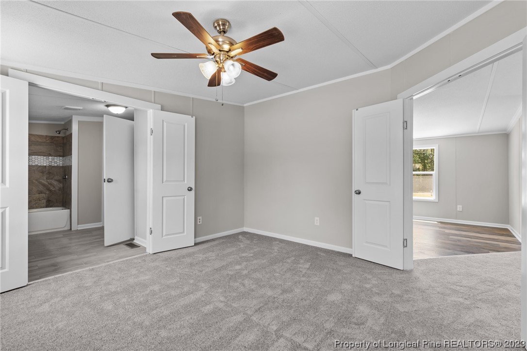 1770 Ashemont Road Aberdeen, NC 28315 - Photo 12 of 29 an empty room with closet and a ceiling fan