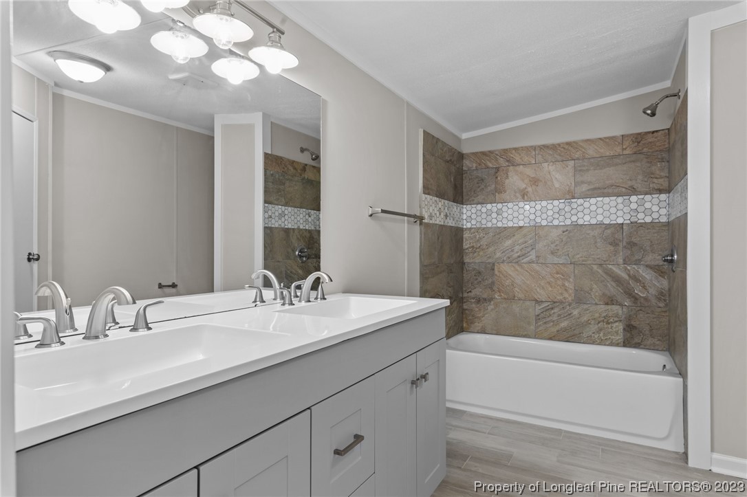 1770 Ashemont Road Aberdeen, NC 28315 - Photo 13 of 29 a bathroom with a sink double vanity mirror and a bathtub