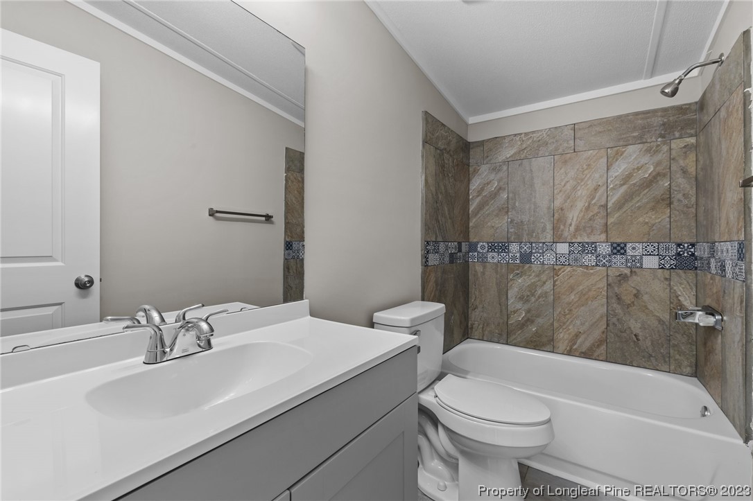 1770 Ashemont Road Aberdeen, NC 28315 - Photo 15 of 29 a bathroom with a sink toilet and shower