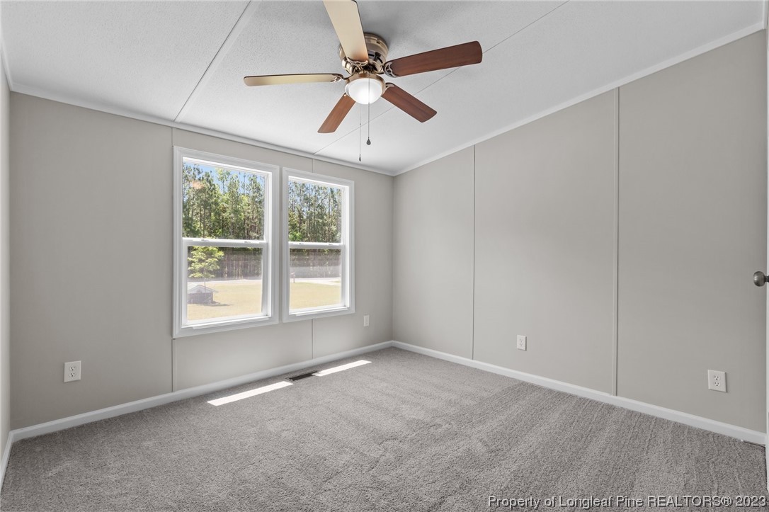 1770 Ashemont Road Aberdeen, NC 28315 - Photo 16 of 29 an empty room with fan and windows