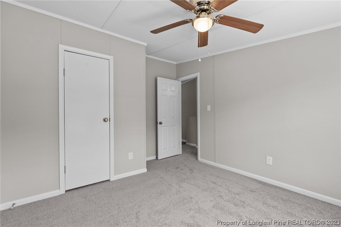1770 Ashemont Road Aberdeen, NC 28315 - Photo 17 of 29 an empty room with closet and a chandelier fan