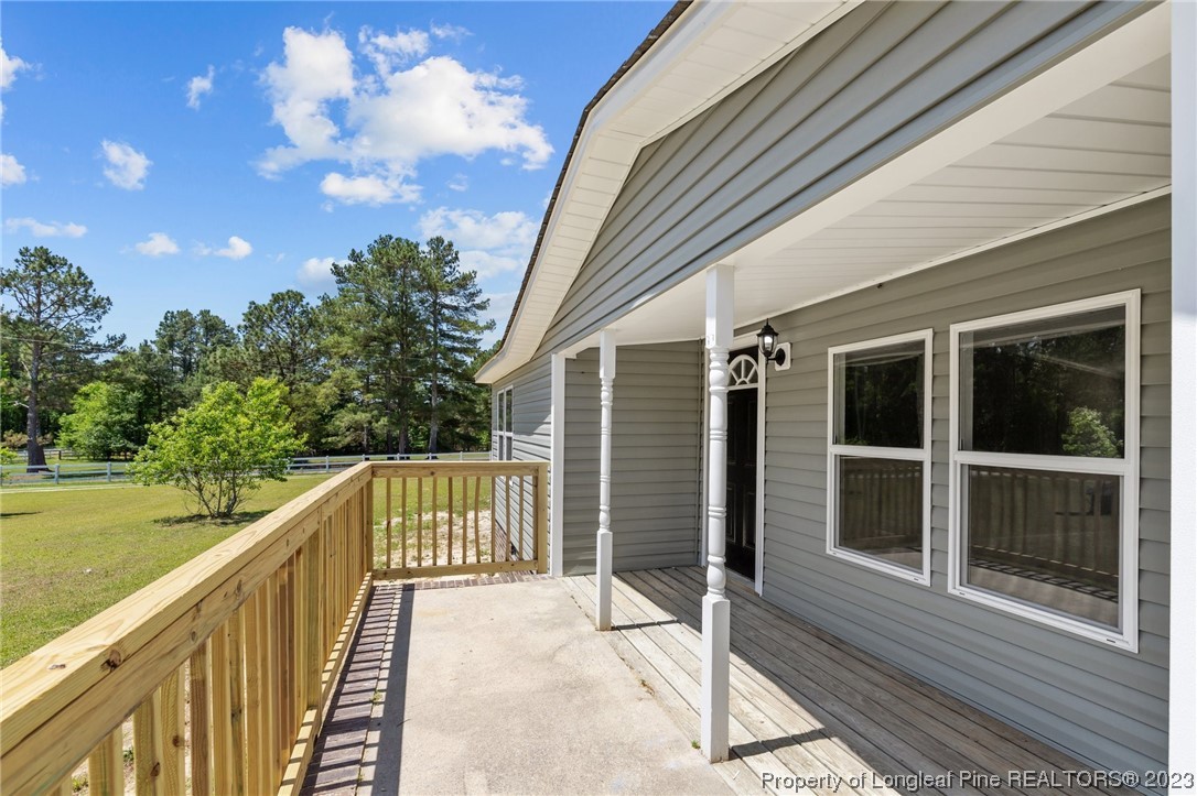 1770 Ashemont Road Aberdeen, NC 28315 - Photo 25 of 29 a view of a balcony with floor to ceiling windows with wooden floor