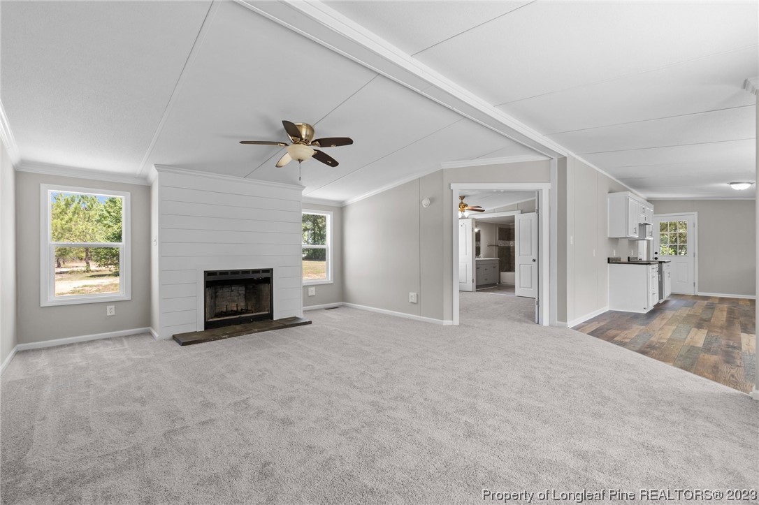1770 Ashemont Road Aberdeen, NC 28315 - Photo 6 of 29 a view of an empty room with a fireplace and a window