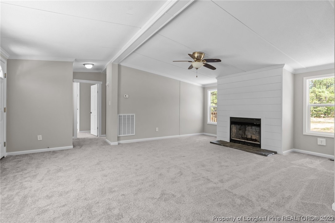 1770 Ashemont Road Aberdeen, NC 28315 - Photo 7 of 29 an empty room with fan and windows