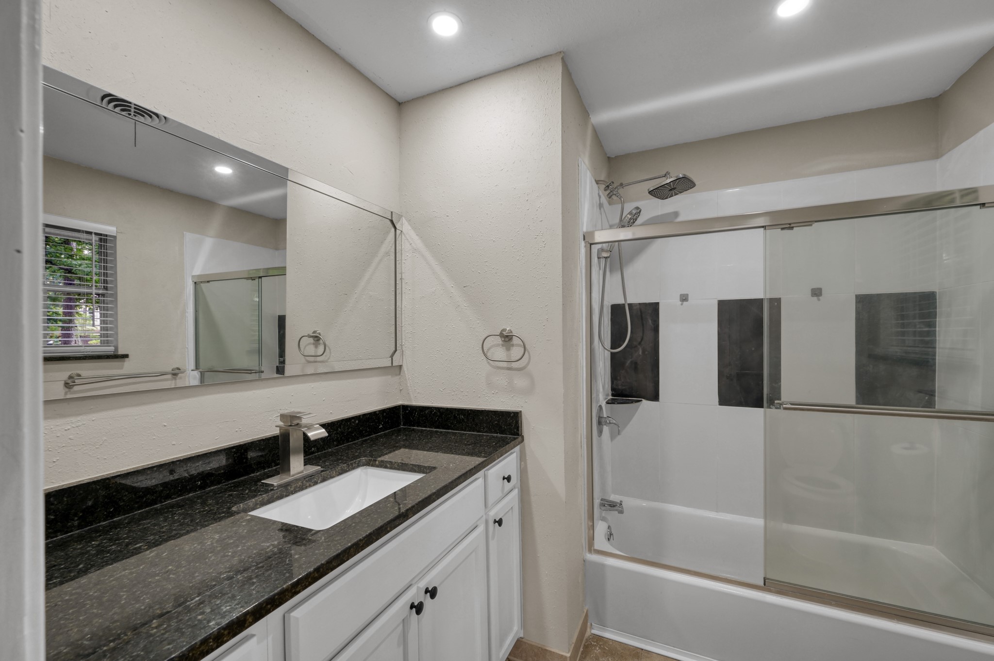 13544 Northshore Loop Conroe, TX 77304 - Photo 24 of 34 Bathroom includes granite countertops, new tile in the shower, and a large vanity for added storage and convenience.