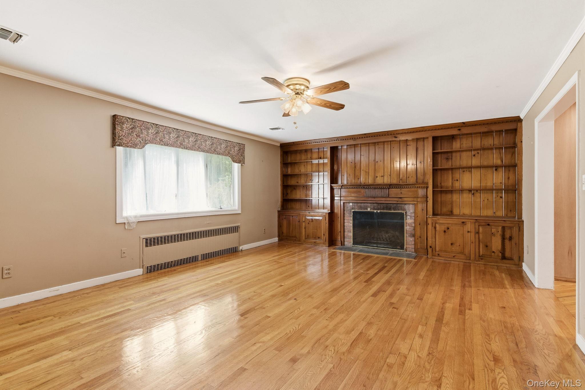 380 Duck Pond Road Locust Valley, NY 11560 - Photo 21 of 41 Den with hardwood floors and fireplace