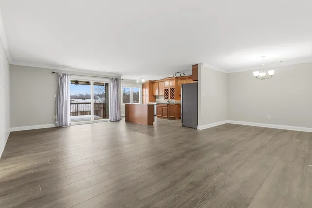 a view of a kitchen with a sink and a refrigerator
