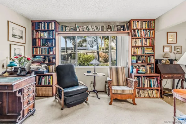 a living room with furniture and a bookshelf