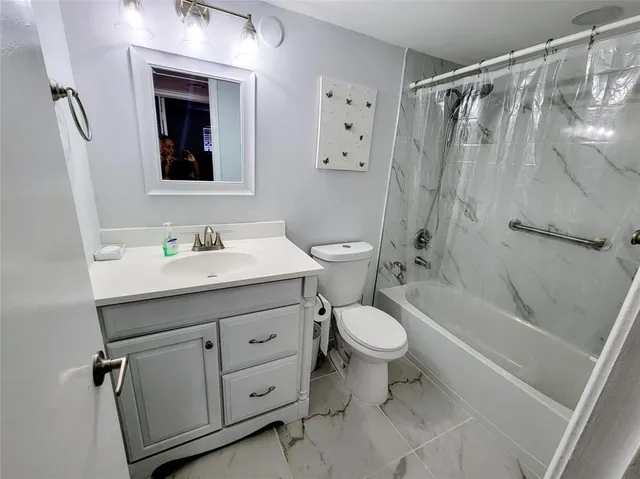 a bathroom with a sink toilet a shower a vanity and mirror