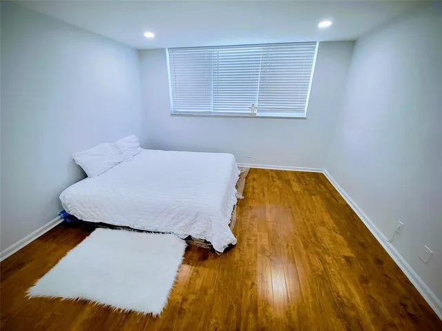 a bed sitting in a room next to a bathroom