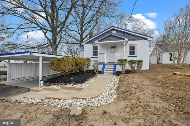 a view of a house with a yard covered in snow