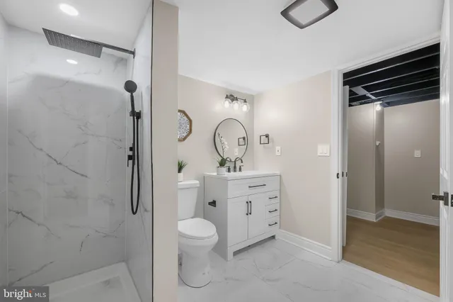 a bathroom with a toilet a sink and shower