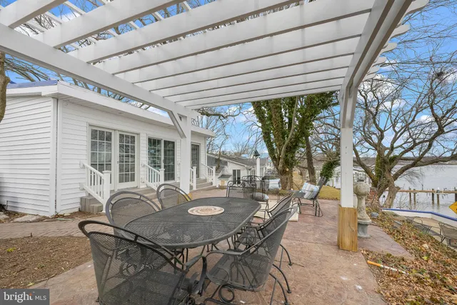 a backyard of a house with table and chairs