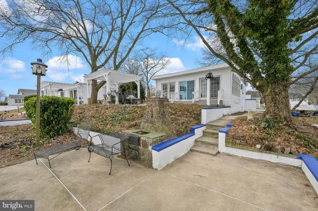 a house view with a sitting space and garden