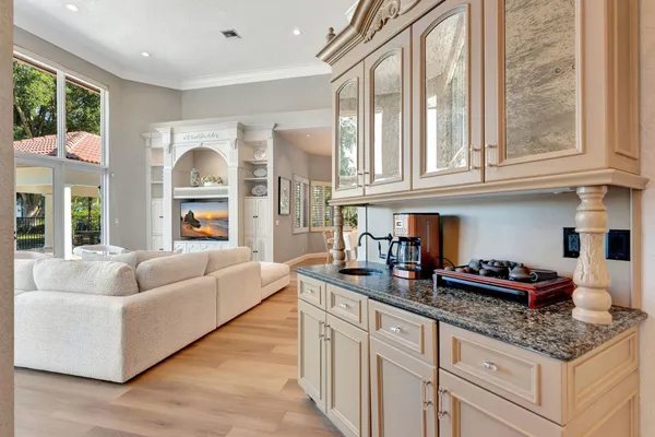 a kitchen with stainless steel appliances granite countertop a large stove a sink dishwasher and a refrigerator with wooden floor