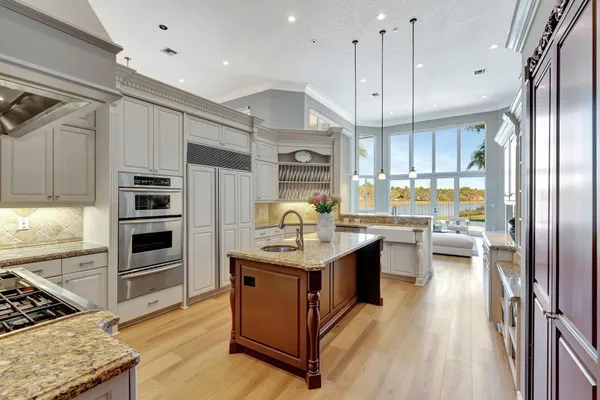a dining room with wooden floor and a chandelier