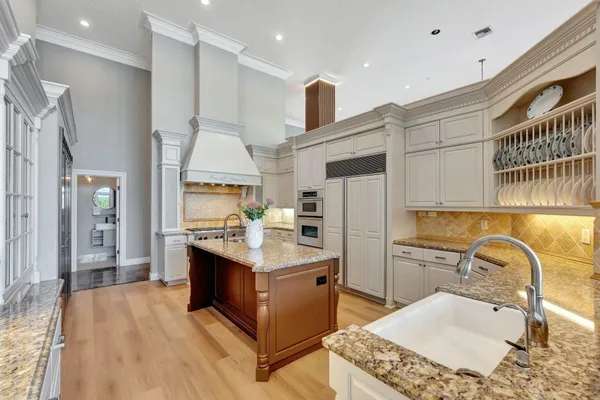 a bathroom with a granite countertop sink a mirror and shower