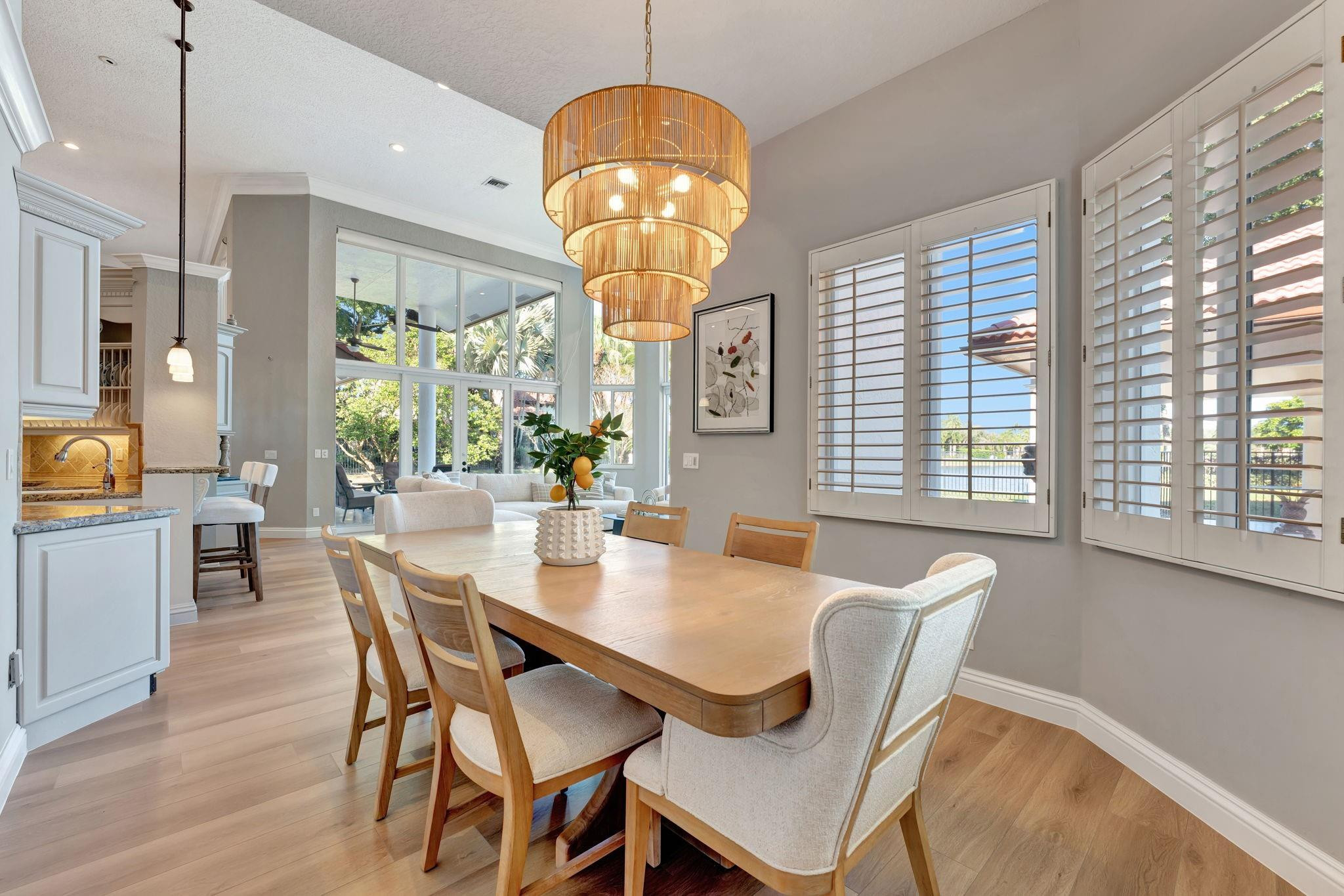 3460 Windmill Ranch Road Weston, FL 33331 - Photo 29 of 75 a view of a dining room with furniture wooden floor and chandelier