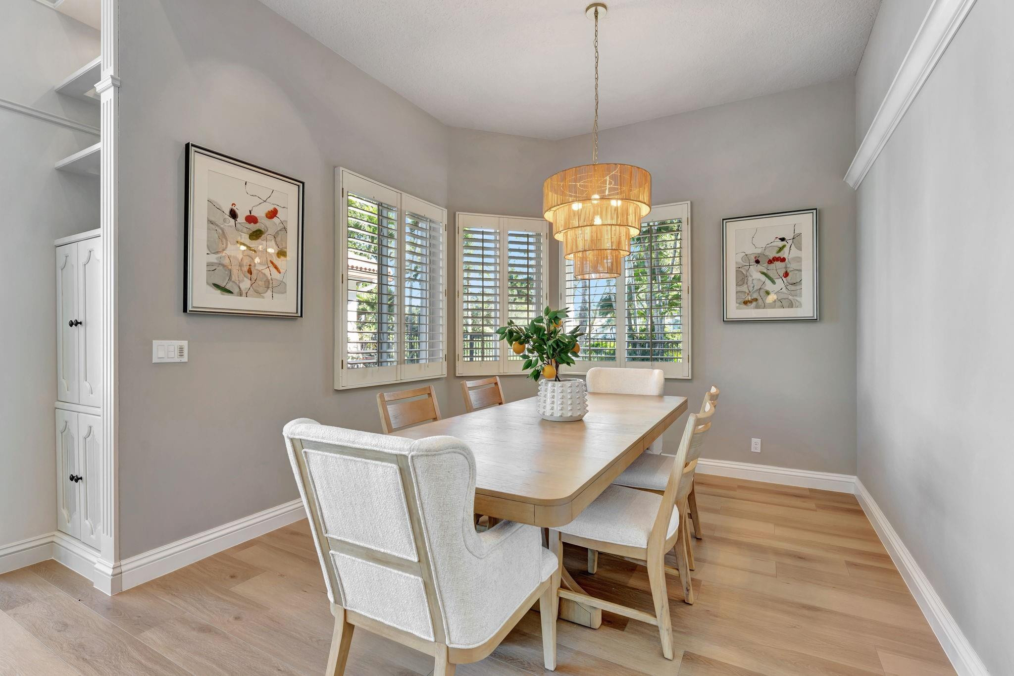 3460 Windmill Ranch Road Weston, FL 33331 - Photo 30 of 75 a dining room with wooden floor and a chandelier
