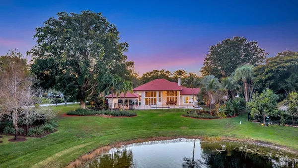 a front view of a house with a yard table and chairs