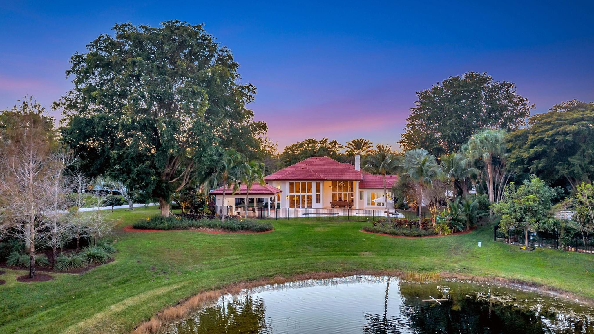 3460 Windmill Ranch Road Weston, FL 33331 - Photo 3 of 75 a front view of a house with a yard table and chairs