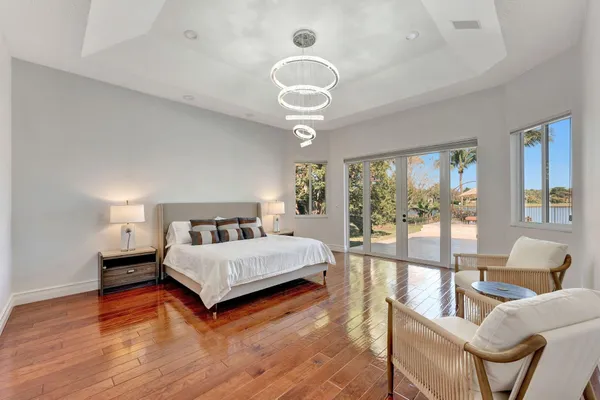 a bedroom with a bed and a chandelier