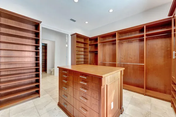 a front view of a house with yard and green space