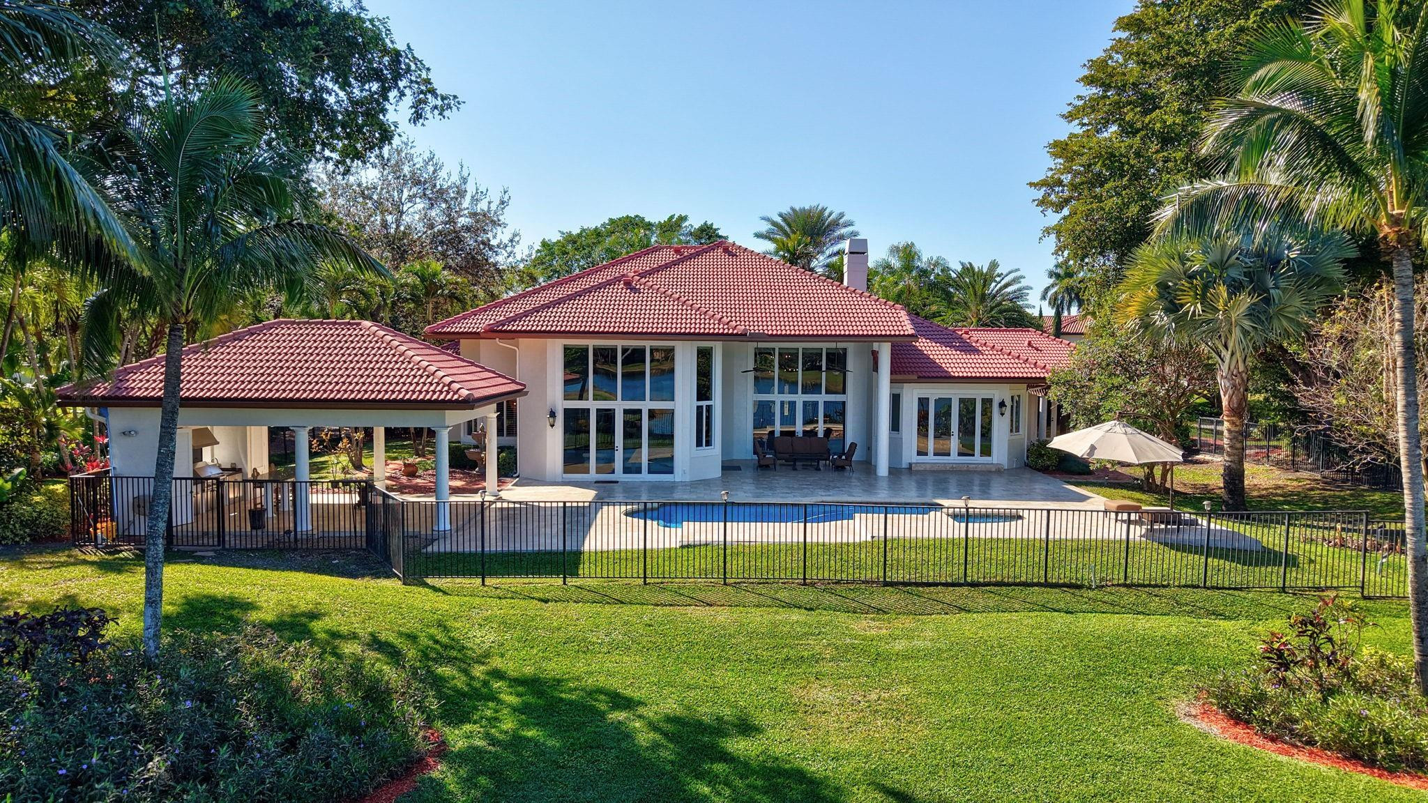 3460 Windmill Ranch Road Weston, FL 33331 - Photo 71 of 75 a swimming pool view with a seating space and a garden view