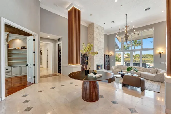 a living room with furniture a fireplace and a potted plant