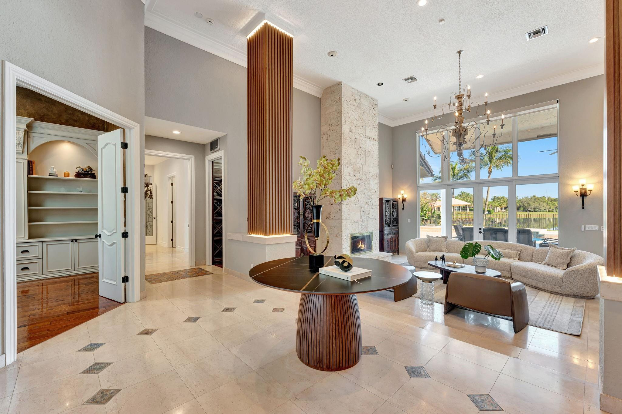 3460 Windmill Ranch Road Weston, FL 33331 - Photo 9 of 75 a living room with furniture and a chandelier